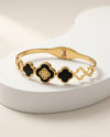 Gold Tone Clover Bangle Bracelet with Black Inlays and Filigree Center