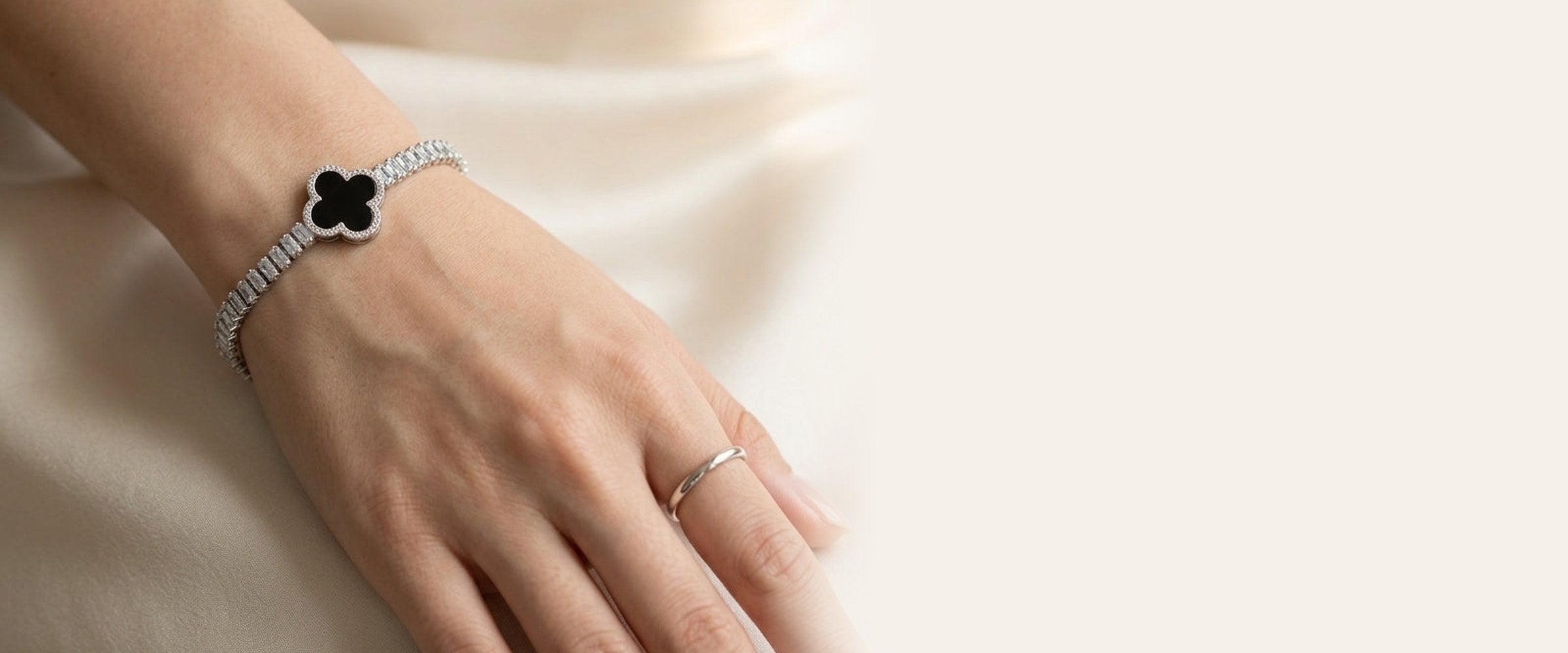 Silver clover tennis bracelet on wrist